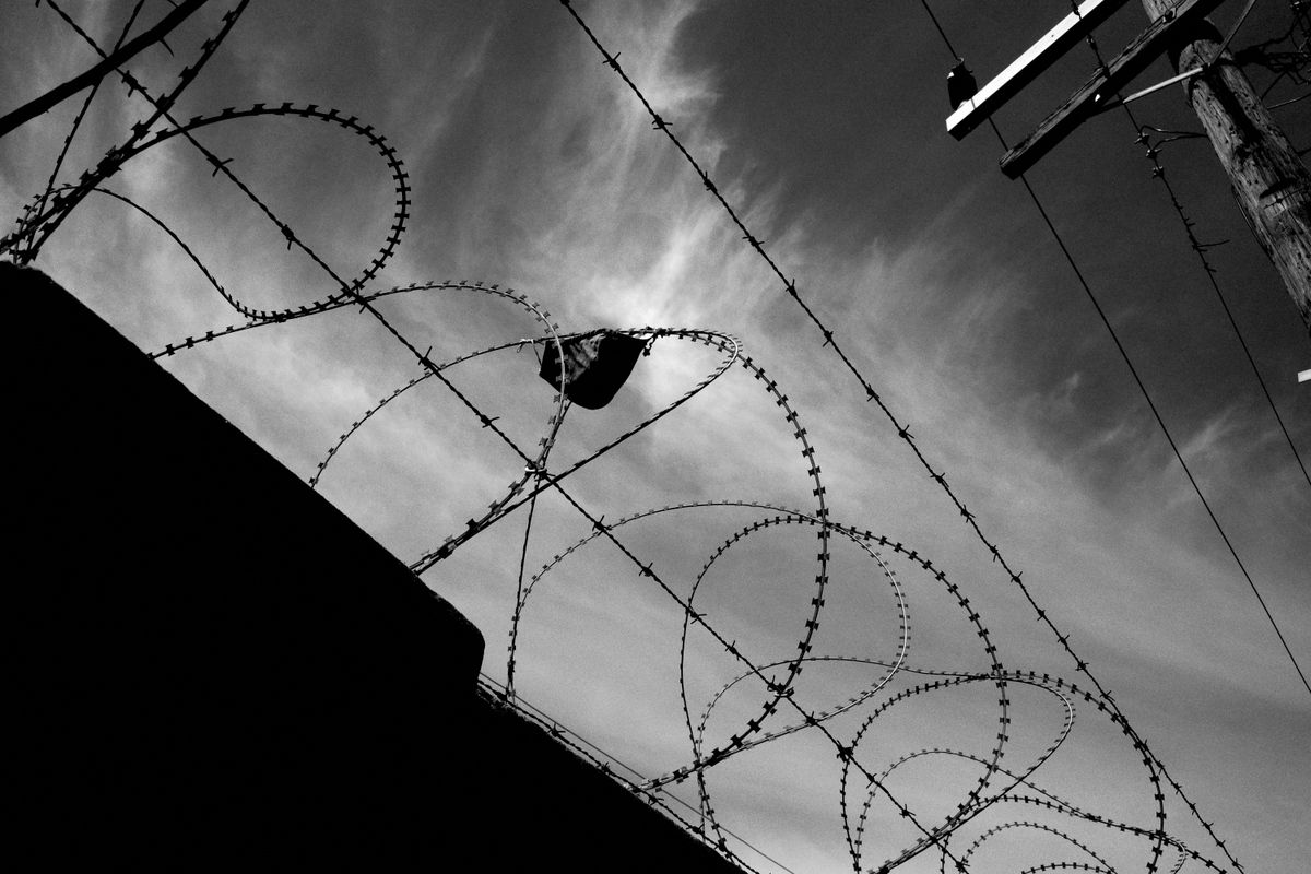 Facemask stuck in barbed wire