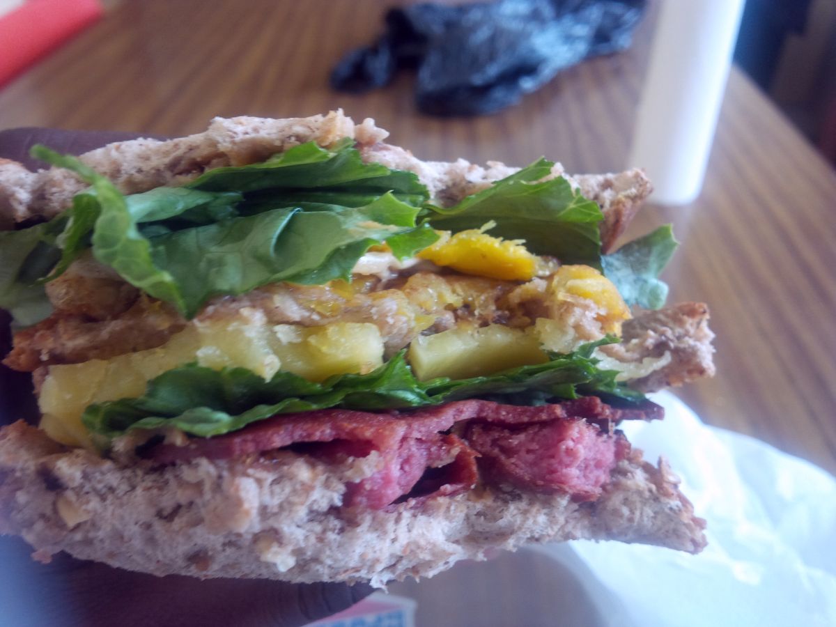 Lunch. Lettuce, chicken sausages, cheddar cheese, egg, salami, ripe fried plantain, peanut butter. Yeah peanut butter on 3 slices of raisin, oats and cinnamon bread. 